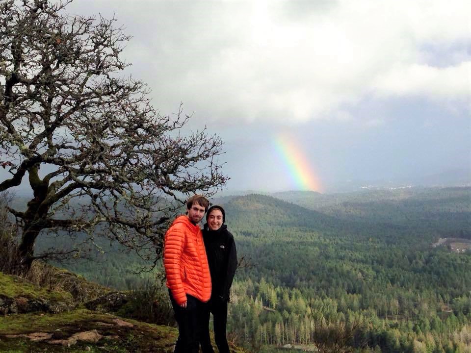 Daniel and Leanna in front of a rainbow