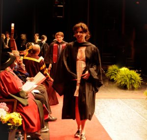 Graduate crossing the stage at Convocation