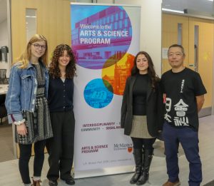 three students standing with a grad, Bruce Miyashita (Artsci 1984)