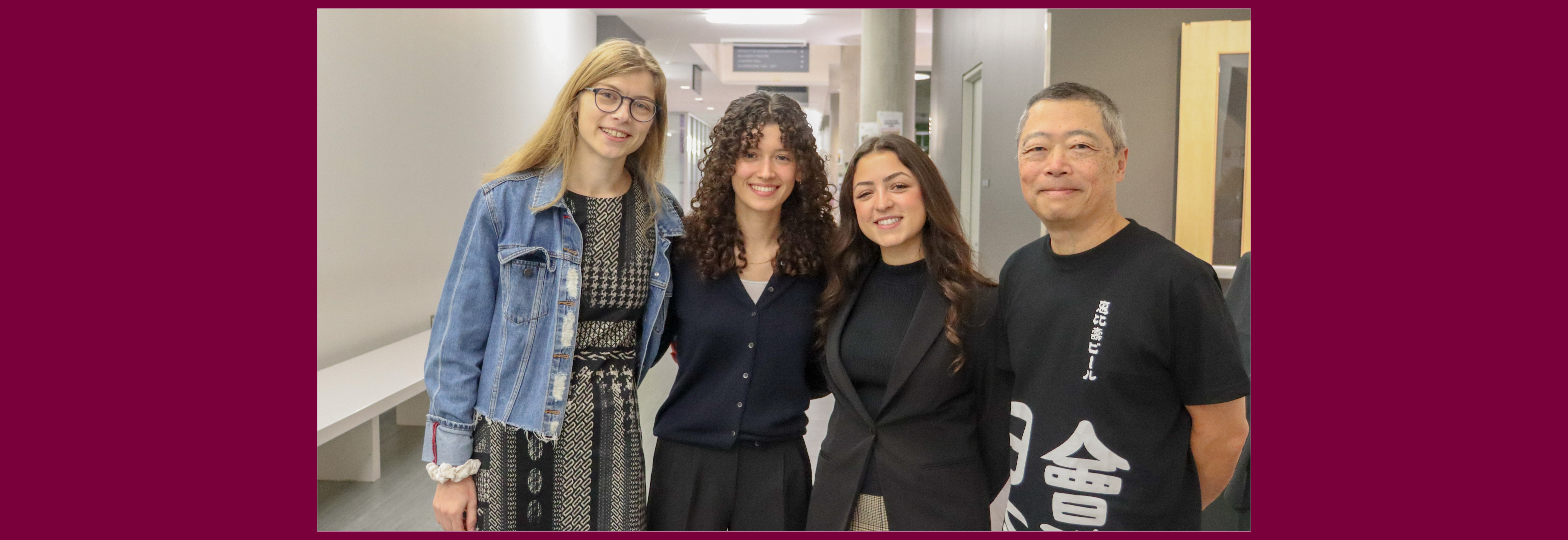 Tthree students standing with a grad, Bruce Miyashita (Artsci 1984)